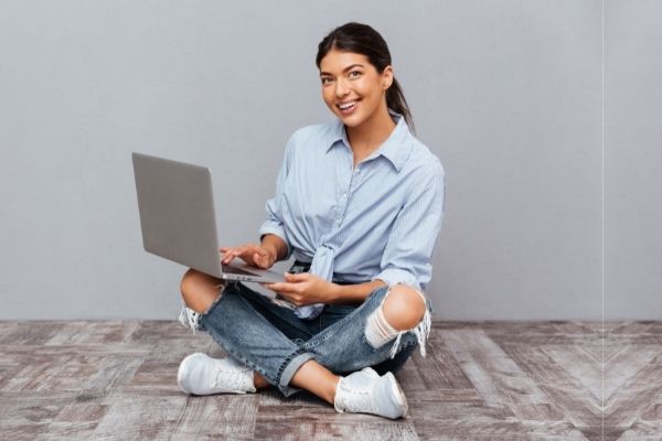 Woman sitting on floor with laptop