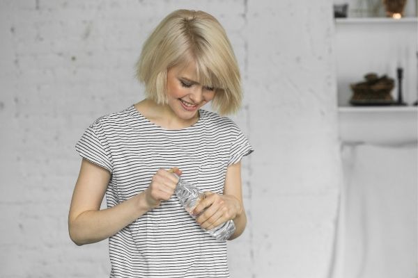 Woman using grip strength to open bottle