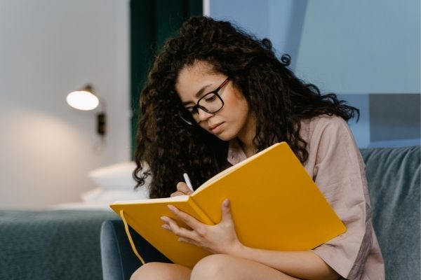 Woman writing down inner work exercise